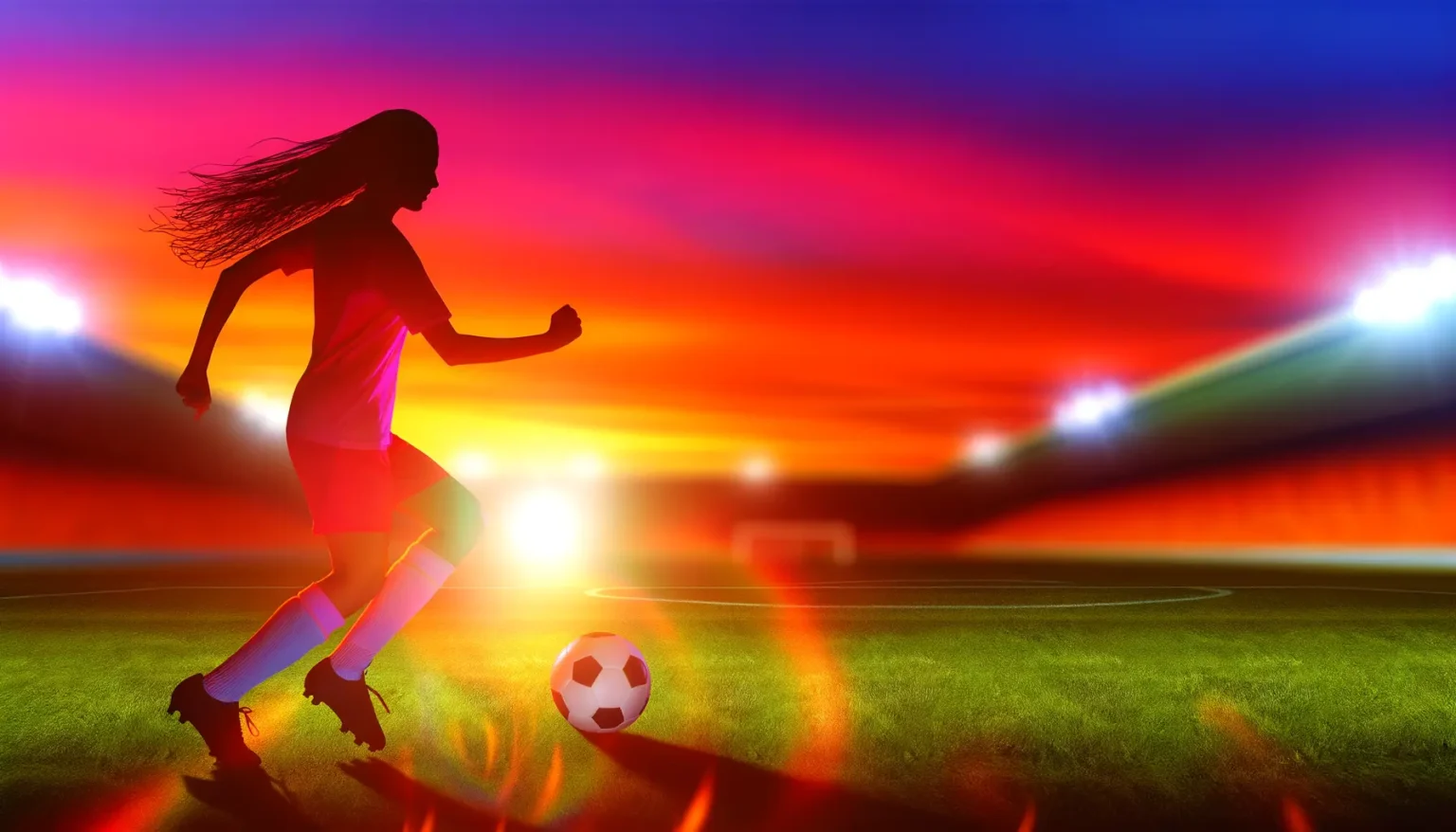 Eine weibliche Fußballspielerin im Trikot spielt mit einem Fußball auf einem Spielfeld, mit einem lebhaften, farbenfrohen Sonnenuntergangshimmel im Hintergrund und den Scheinwerfern eines Stadions, die das Feld erleuchten.